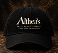 Black Althea's signature cap with logo, front view, on textured dark studio background