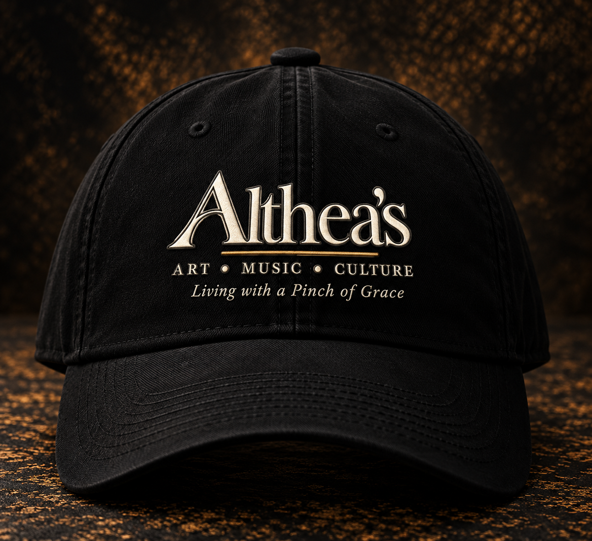 Black Althea's signature cap with logo, front view, on textured dark studio background