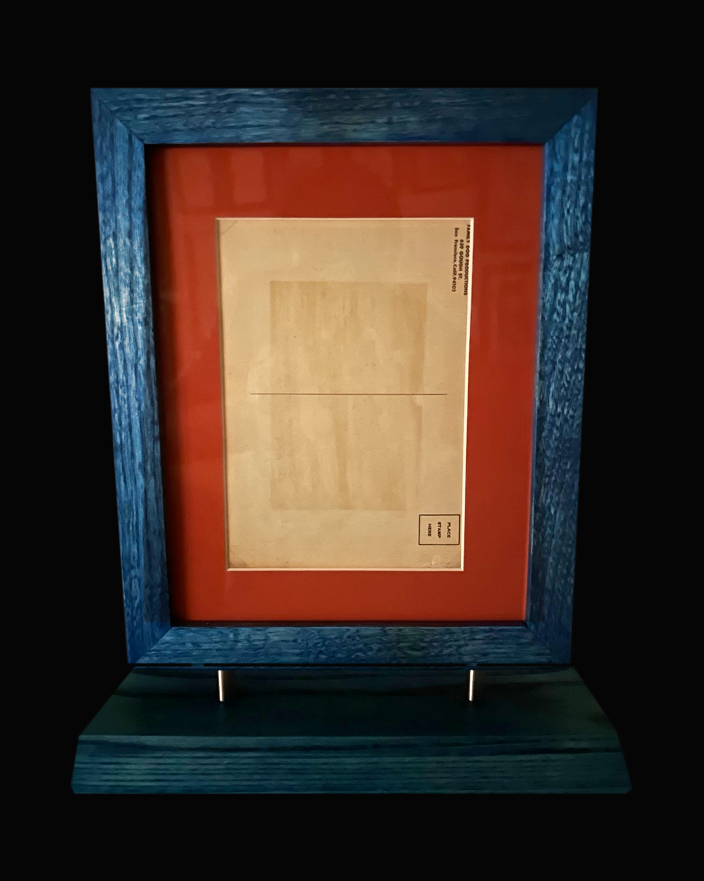 Reverse of 1967 Rick Griffin postcard, blue frame and stand on black