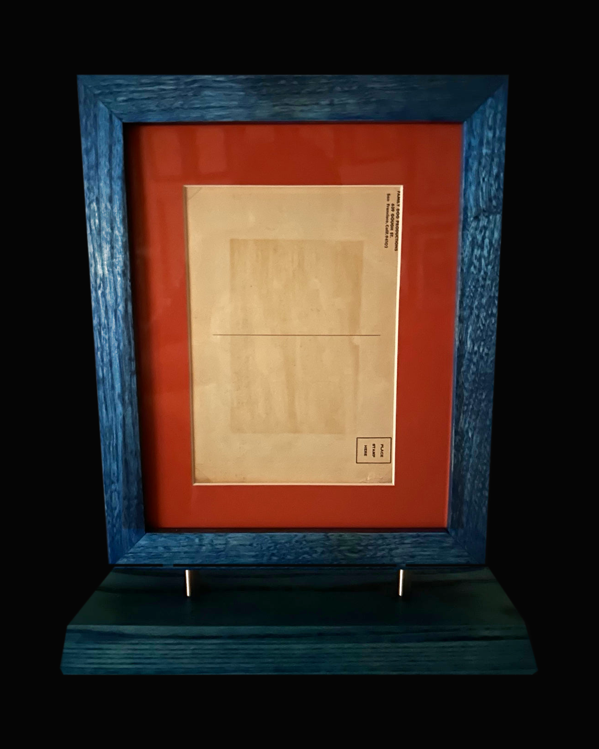 Reverse of 1967 Rick Griffin postcard, blue frame and stand on black