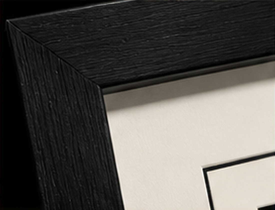 Close-up of the black wood gallery frame and white mat