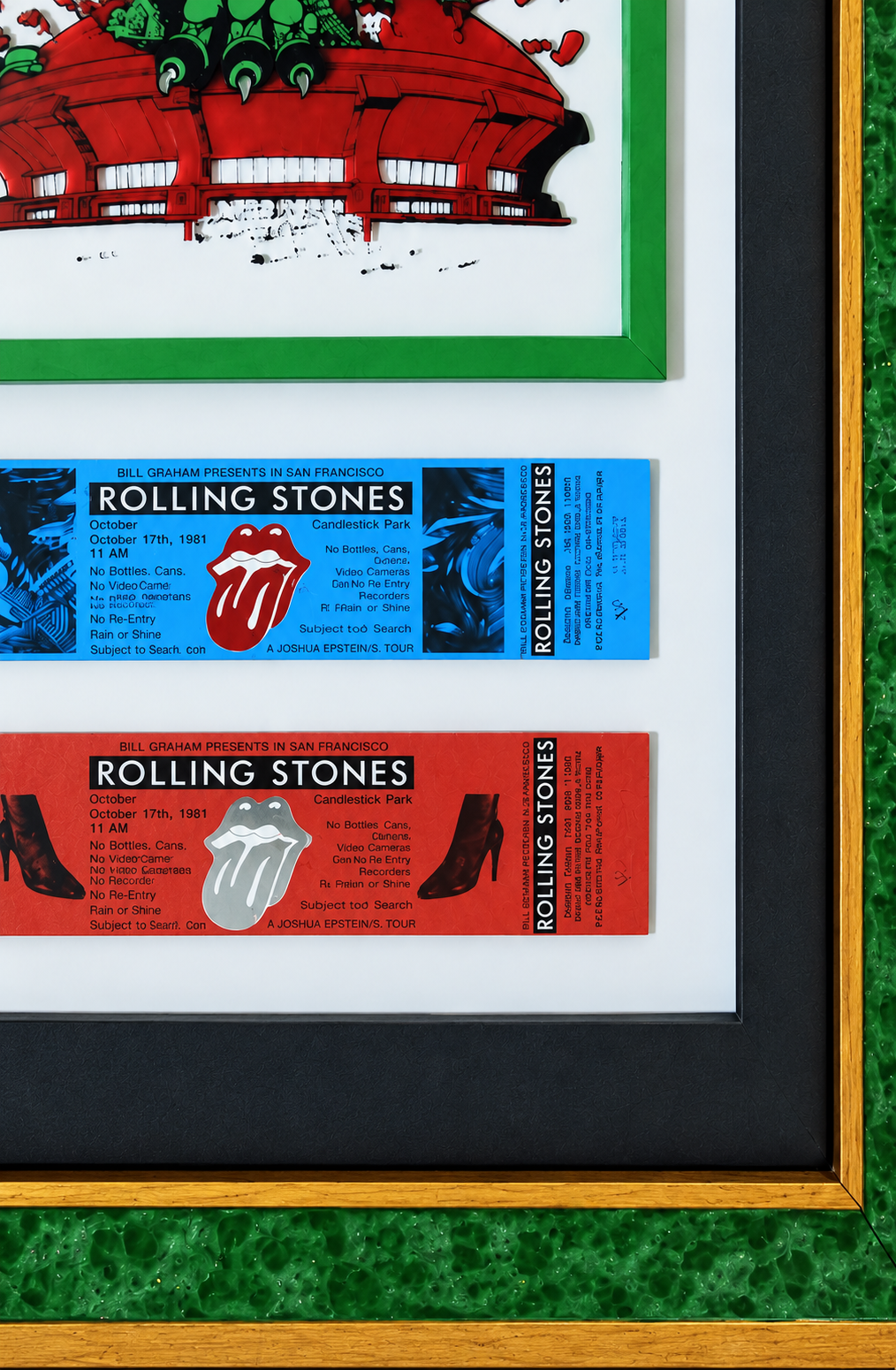 Close-up of Rolling Stones concert tickets and custom green and gold frame corner