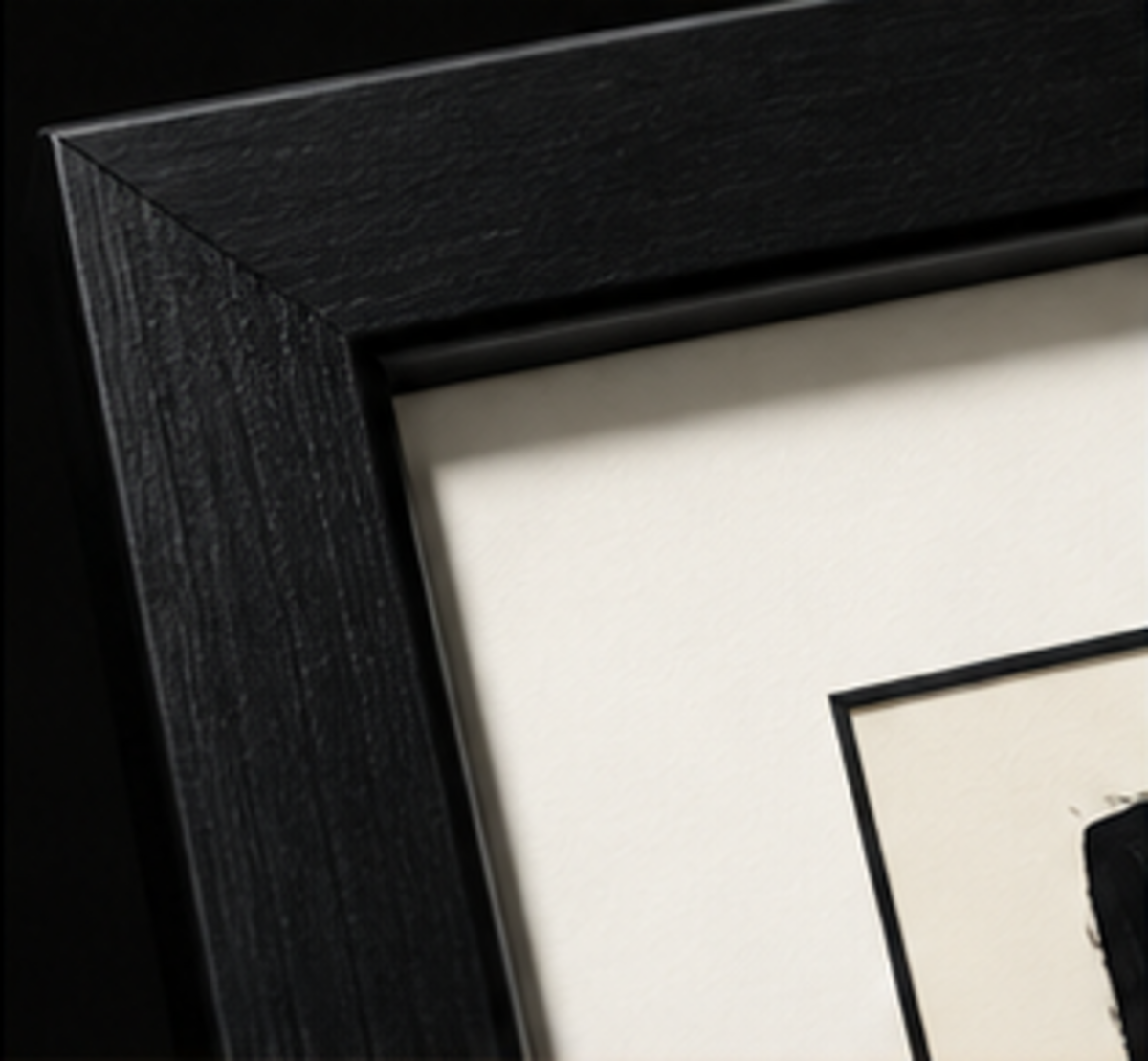 Black wooden gallery frame and white mat detail